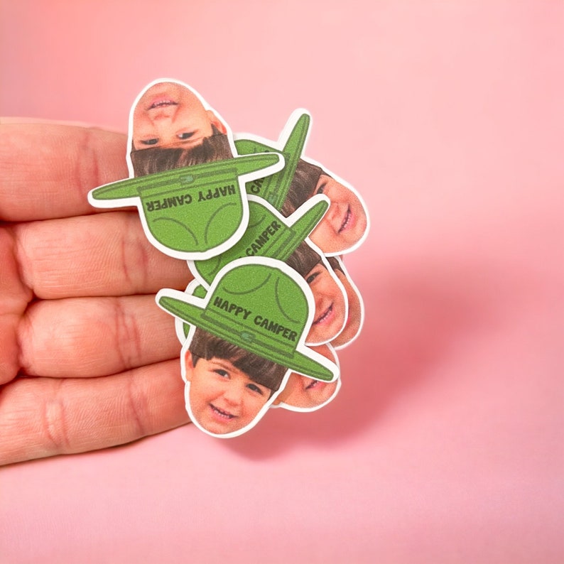 Personalized happy camper confetti featuring a photo of the birthday girl or boy with a camp hat on.