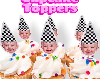 May include: Cupcake toppers featuring a smiling baby face wearing a black and white checkered party hat. The text Cupcake Toppers is displayed in large pink letters above the cupcakes, which are topped with white frosting and colorful sprinkles.
