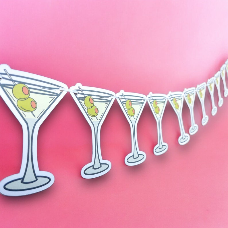 May include: A string of paper martini glass cutouts with green olives, perfect for a party or celebration.