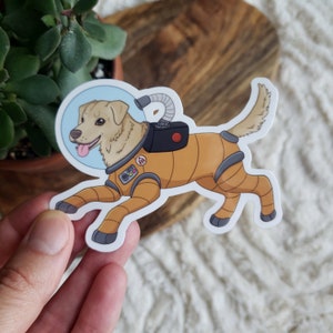 Space Retriever 3.5 » Autocollant en vinyle (brillant) | Space Dog | Astronaute | Combinaison spatiale | Golden Retriever | Imperméable