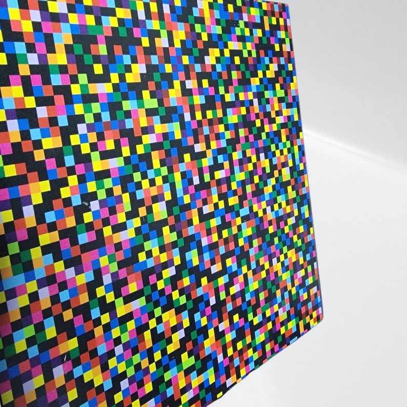 May include: A colourful abstract pattern with a black background. The pattern is made up of small squares in various colours, including red, blue, green, yellow, and purple.