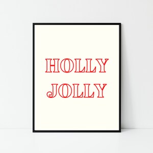 May include: A black framed print with the words "HOLLY JOLLY" in red text on a white background.