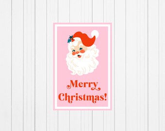 May include: A pink card with a cartoon image of Santa Claus with a red hat and white beard. The text "Merry Christmas!" is written in red letters below the image.