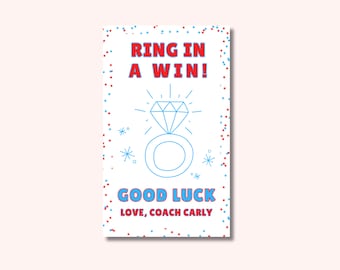 May include: A white card with red and blue confetti. The card says "Ring in a win!" with a blue and white outline of a diamond ring. The card also says "Good luck, Love, Coach Carly".