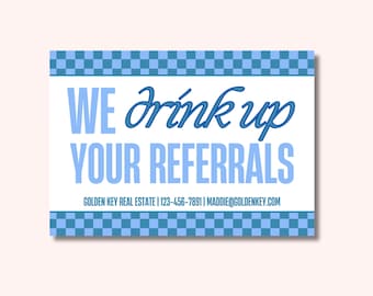 May include: A rectangular sign with a white background and blue text that reads "WE drink up YOUR REFERRALS". The sign has a blue checkered border and includes contact information for Golden Key Real Estate.