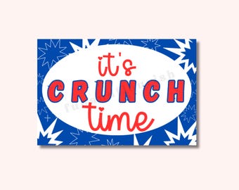 May include: A white speech bubble with a blue background and red stars. The speech bubble says "it's crunch time".