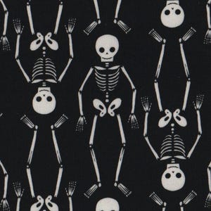 May include: Black fabric featuring a repeating pattern of white skeletons. The skeletons are shown in various poses, some upright and some inverted, creating a symmetrical design. The skeletons have detailed rib cages and skulls.
