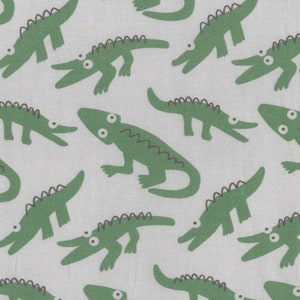 May include: A seamless pattern featuring a repeating design of green alligators on a light grey background. The alligators are facing different directions and have a simple, cartoon-like design.