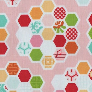 May include: A pink fabric with a repeating pattern of colourful hexagons. The hexagons are filled with various designs, including polka dots, flowers, and geometric shapes.