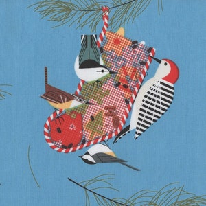 May include: A blue background with a repeating pattern of Christmas stockings filled with colourful gifts and birds. The stockings are hung from pine branches with red and white candy cane stripes.