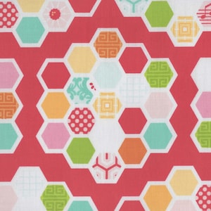 May include: A white fabric with a red honeycomb pattern. Each hexagon is filled with a different colorful pattern, including polka dots, stripes, flowers, and geometric designs.