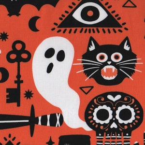 May include: A bright orange fabric with a black and white Halloween pattern. The pattern includes a ghost, a cat, a skull, a key, a dagger, a hand, a bat, and a triangle with an eye inside.