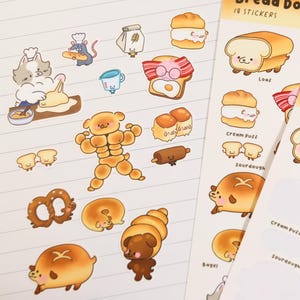 May include: Sticker sheets with cartoon bread characters, such as a loaf, bagel, and croissant. The stickers are on a white, lined paper background and a blue background with the text "Bread Dogs".
