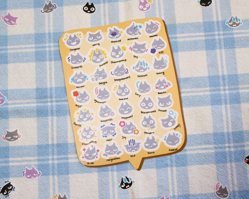 May include: A sheet of stickers featuring gray cats with different facial expressions, each labeled with a corresponding emotion. The emotions include worry, mischief, laughter, sheepish, shy, delight, disagreement, distress, fear, pride, resignation, joy, pleased, bashful, bewildered, intense, sleepy, curious, chill, smirk, and cheese.