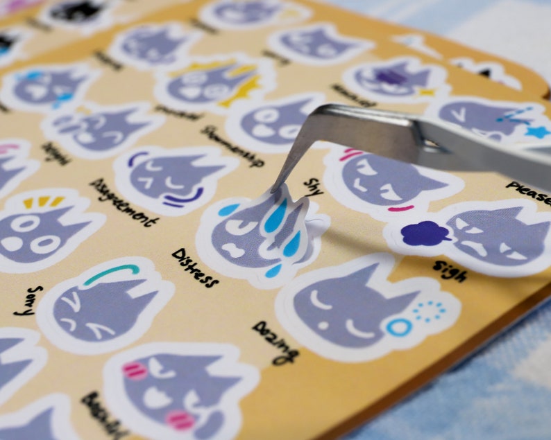 May include: A set of gray cat stickers with different facial expressions and emotions. Each sticker has a word describing the emotion, such as "sorry", "distress", "shy", and "sigh".