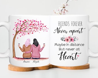 May include: White ceramic mug featuring a heartwarming illustration of two friends under a heart-shaped tree. The mug has the text "FRIENDS FOREVER Never apart, Maybe in distance But never at Heart". Names "Amani Aliyah" are printed at the bottom.