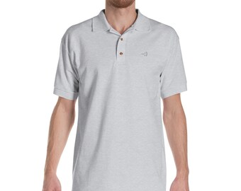 May include: Light gray polo shirt with short sleeves and a collared neckline. The shirt has three brown buttons and a small embroidered smiley face on the chest. The shirt is made of a soft, comfortable material.