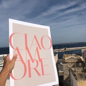 May include: A white poster with a beige background and the text "CIAO AMORE" in pink.