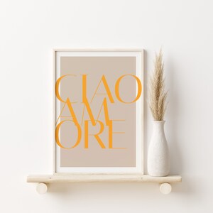 May include: A framed print with a beige background and the text "CIAO AMORE" in orange letters.
