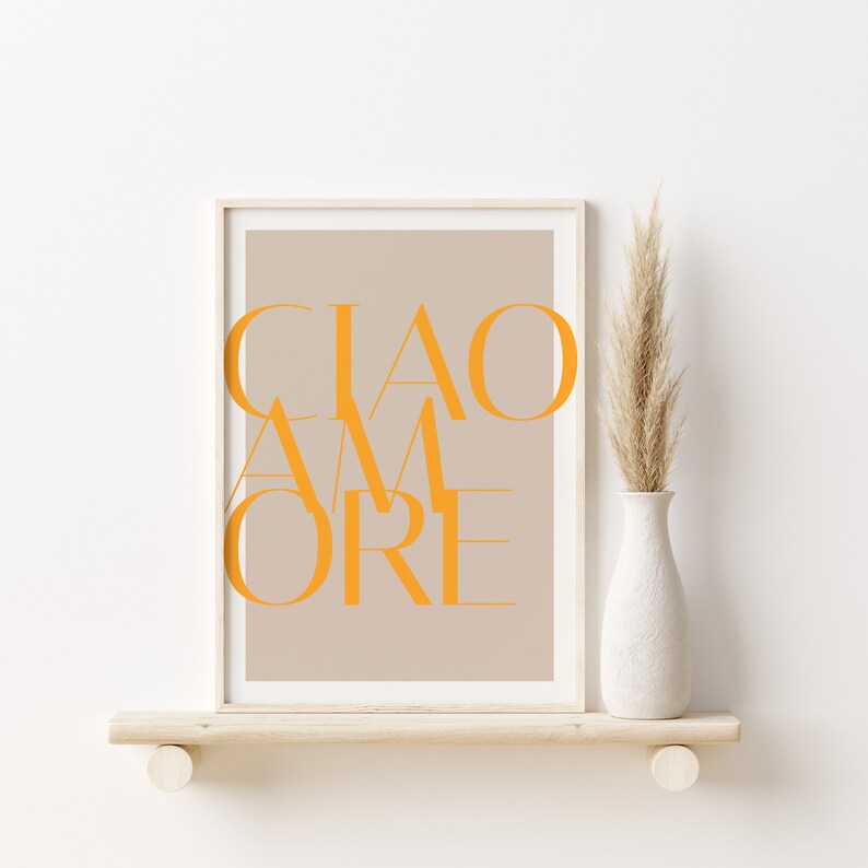 May include: A framed print with a beige background and the text "CIAO AMORE" in orange letters.