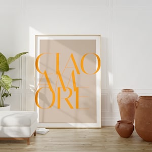 May include: A beige poster with a gold frame featuring the text "CIAO AMORE" in orange letters.
