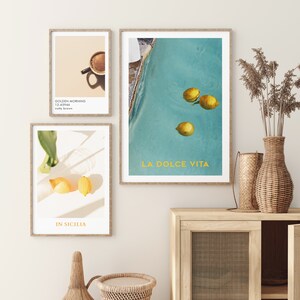 May include: Three framed prints with a summery theme. The first print features a cup of coffee with the text "Golden Morning 12-63966 nutty brown". The second print shows lemons floating in a pool with the text "La Dolce Vita". The third print shows lemons on a white surface with the text "In Sicilia".