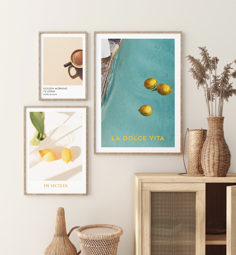 May include: Three framed prints with a summery theme. The first print features a cup of coffee with the text "Golden Morning 12-63966 nutty brown". The second print shows lemons floating in a pool with the text "La Dolce Vita". The third print shows lemons on a white surface with the text "In Sicilia".