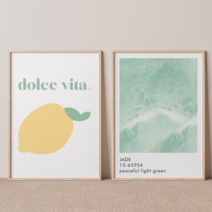 May include: Two framed prints, one with the text "dolce vita." and a yellow lemon with a green leaf, the other with a green marble texture and the text "JADE 12-65954 peaceful light green."