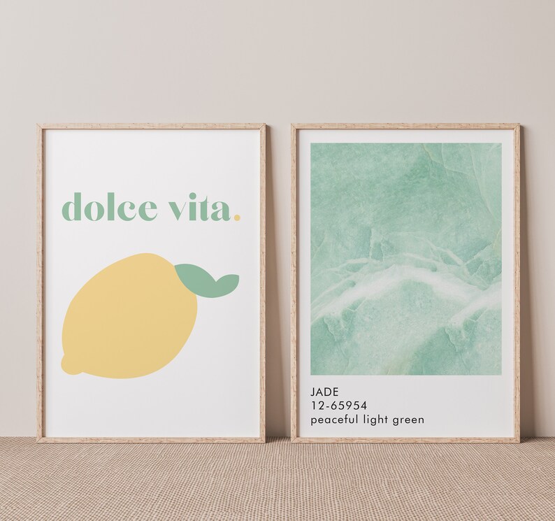 May include: Two framed prints, one with the text "dolce vita." and a yellow lemon with a green leaf, the other with a green marble texture and the text "JADE 12-65954 peaceful light green."