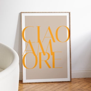 May include: A framed print with a beige background and the text "CIAO AMORE" in orange.