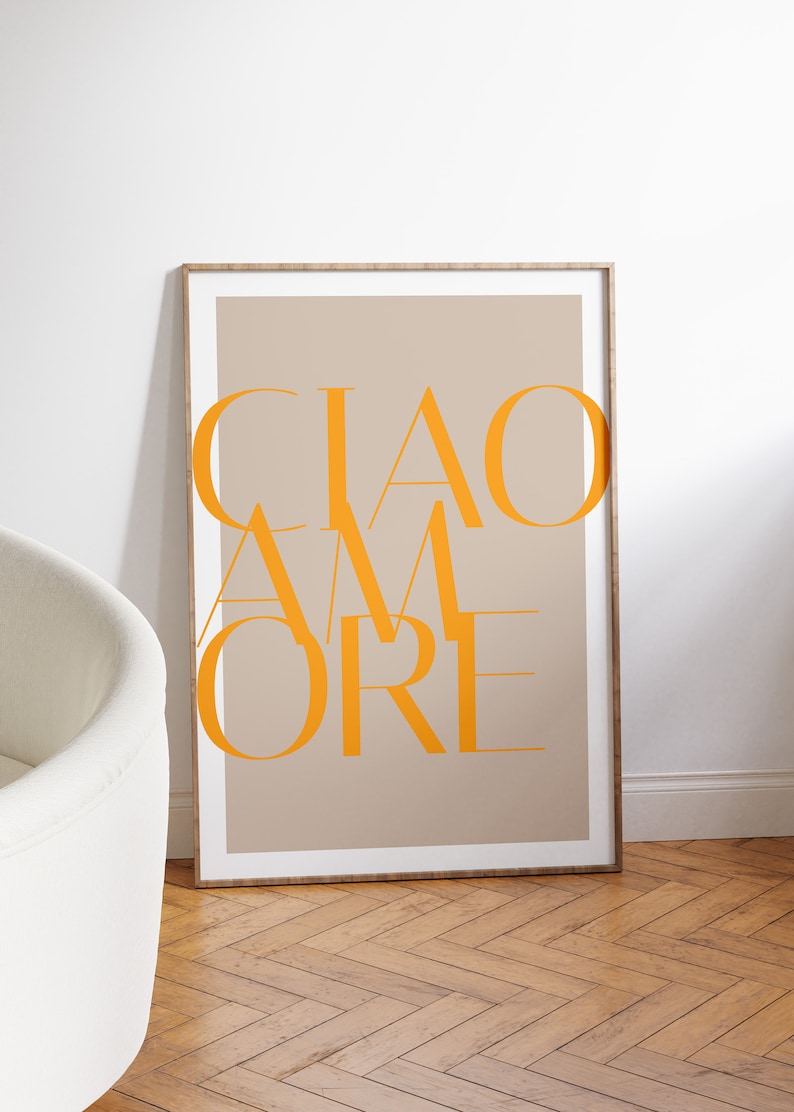 May include: A framed print with a beige background and the text "CIAO AMORE" in orange.