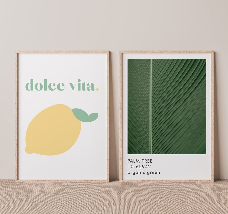 May include: Two framed prints, one with the text "dolce vita." and a yellow lemon illustration, the other with a close-up of a green palm leaf with the text "PALM TREE 10-65942 organic green"