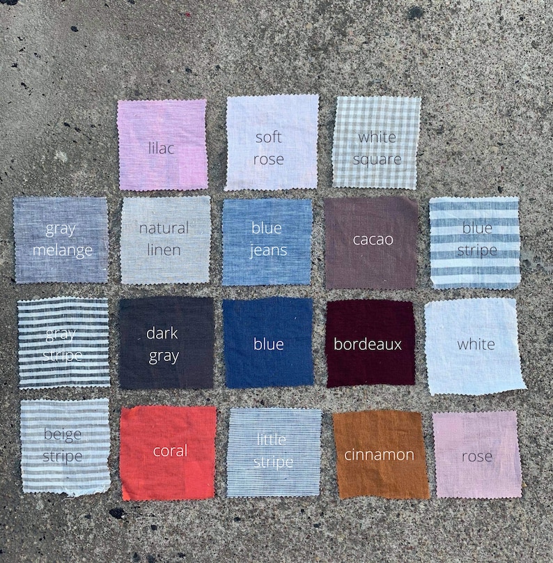 May include: A collection of 16 fabric swatches in various colors and patterns, including white, gray, blue, beige, coral, rose, lilac, and brown. The swatches are arranged in a grid pattern on a gray concrete surface. Each swatch has a label with a descriptive name, such as "soft rose", "white square", "blue jeans", and "natural linen".