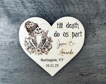 May include: A wooden heart-shaped plaque with a laser-etched design of two skeletons embracing, surrounded by roses. The text "till death do us part" is above the names "Jason & Amanda" and the date 10.31.25, with "Burlington, VT" below.