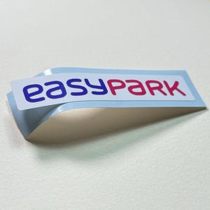 May include: A white sticker with the text "easyPARK" in blue and pink lettering.