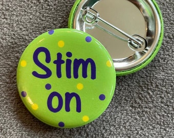 May include: Green button with yellow and purple polka dots. The button says "Stim on" in purple lettering.
