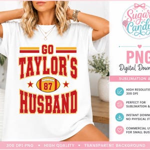 May include: A white short-sleeve t-shirt featuring a graphic design with the text GO TAYLOR'S HUSBAND in red and yellow block letters. A yellow and red football graphic with the number 87 is centered between the words, flanked by two red stars.