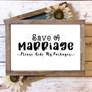 May include: A white sign with black text that reads "Save a Marriage - Please Hide My Packages". The sign is framed in a rustic wooden frame.