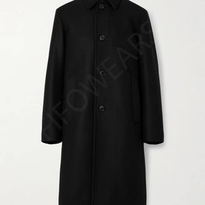 May include: A black long-sleeved coat with a button-up front and a collar. The coat has a simple design and is made of a soft, warm fabric.