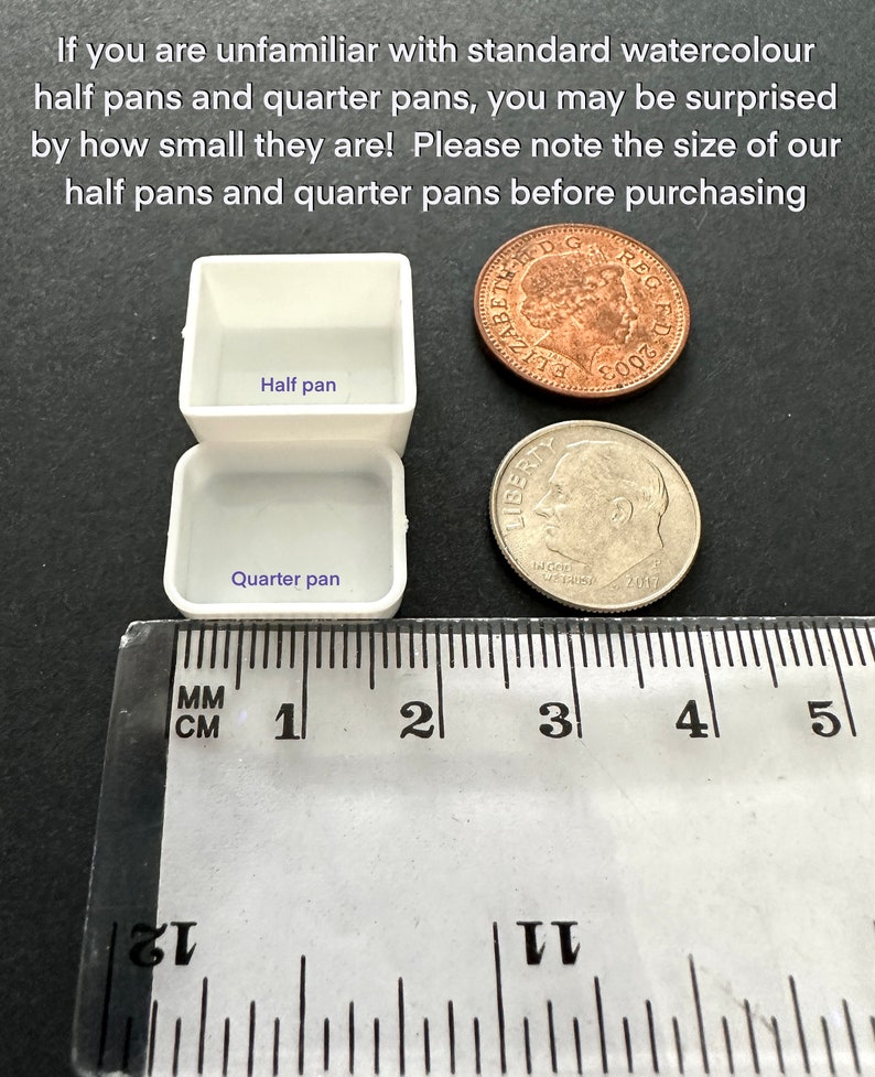 May include: Two white watercolour paint pans, labelled "Half pan" and "Quarter pan", are shown next to a ruler and two UK coins. The ruler measures 5 centimetres.