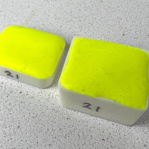 May include: Two bright yellow paint squares, both labelled with the number "21".