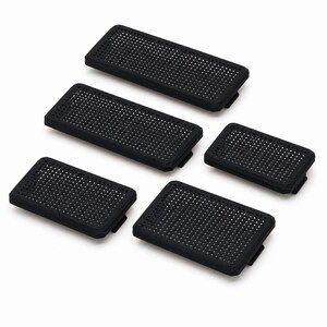 May include: A set of five rectangular black components featuring a uniform grid of small circular perforations across the top surface. Each piece has a slightly raised border and a small tab extending from one of the shorter sides of the base.