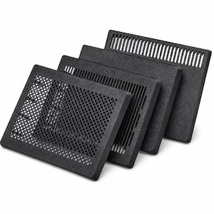 May include: A set of four rectangular black ventilation grilles arranged in a staggered row. Each grille features a distinct pattern, including a diamond-shaped mesh, vertical slats, and a solid panel with a top row of vertical slots.