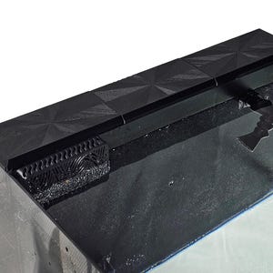 May include: Black terrarium top with a decorative geometric pattern. The top features a ventilation grate and a hinged access point. The terrarium is designed for reptiles or amphibians.