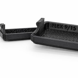May include: A black 3D-printed rectangular tray with a grid-patterned base and raised edges. The side features the embossed text "FLEX 9/15" and "FishGuildCo". The object has a layered texture characteristic of additive manufacturing processes.