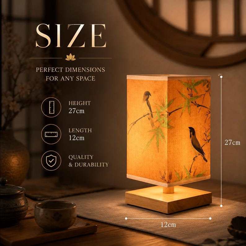 May include: A rectangular table lamp with a light wood base and a fabric shade featuring a print of birds and bamboo branches. The lamp measures 27 cm in height and 12 cm in length. Text on the image includes SIZE, PERFECT DIMENSIONS FOR ANY SPACE, HEIGHT 27cm, LENGTH 12cm, and QUALITY & DURABILITY.