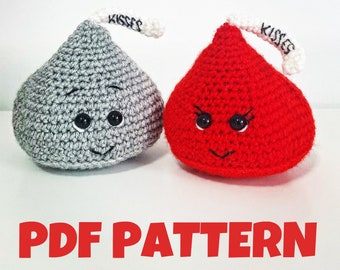 May include: Two crocheted Kiss-shaped plush toys. One is gray with a happy face and the other is red with an angry face. Both have white "Kisses" labels on their tops.