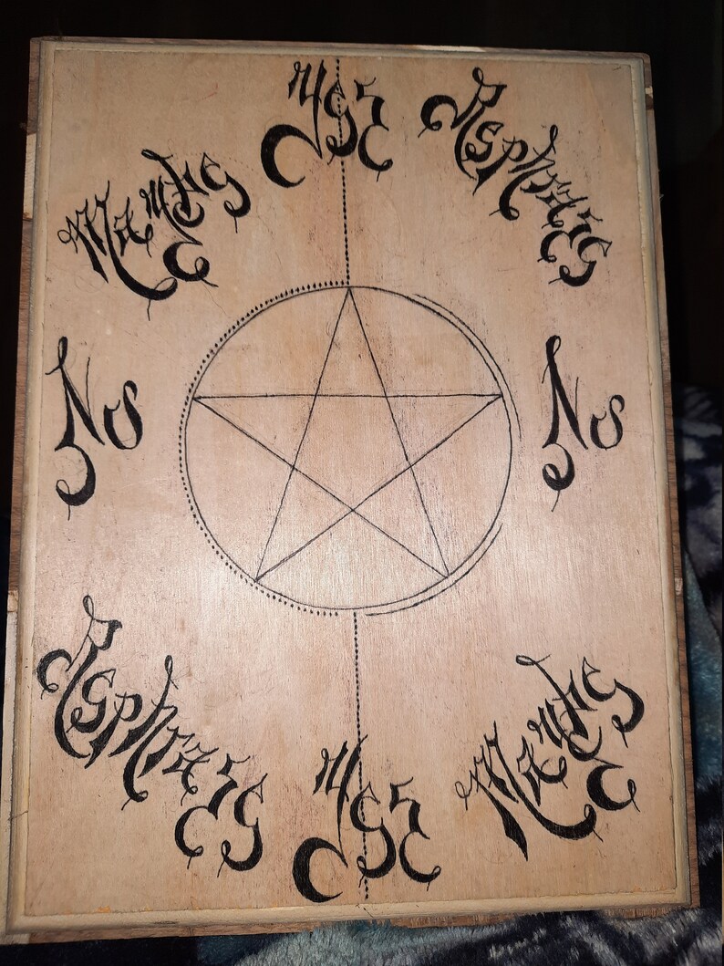 May include: A wooden board with a five-pointed star drawn in the center. The star is surrounded by a circle with a dotted line. The words "Nos" and "Mercies" are written in cursive around the circle. The words "Miser" and "Repenting" are written in cursive at the top and bottom of the board.