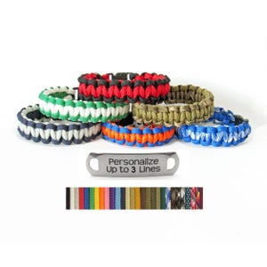 May include: A collection of colorful paracord bracelets in various shades, including red, green, blue, and orange. A metal tag below reads "Personalize Up to 3 Lines." A color chart is at the bottom.