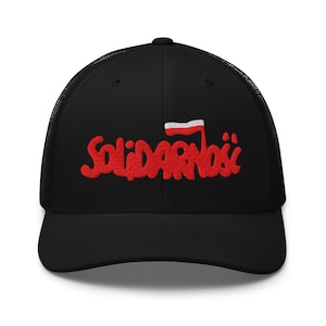 May include: Black trucker cap featuring the Polish word "Solidarność" embroidered in red, with a small Polish flag. The cap has a mesh back and a curved peak.